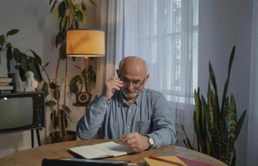 A retiree sitting idly at home, appearing contemplative