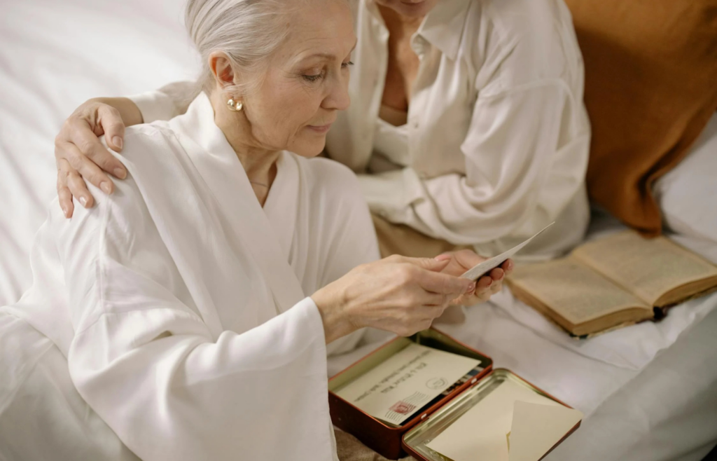 Gray haired woman looking at the old photos