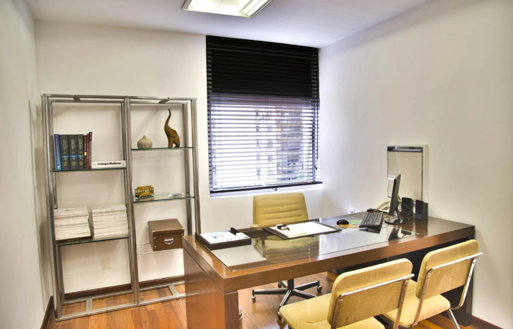 An empty office desk with personal accolades