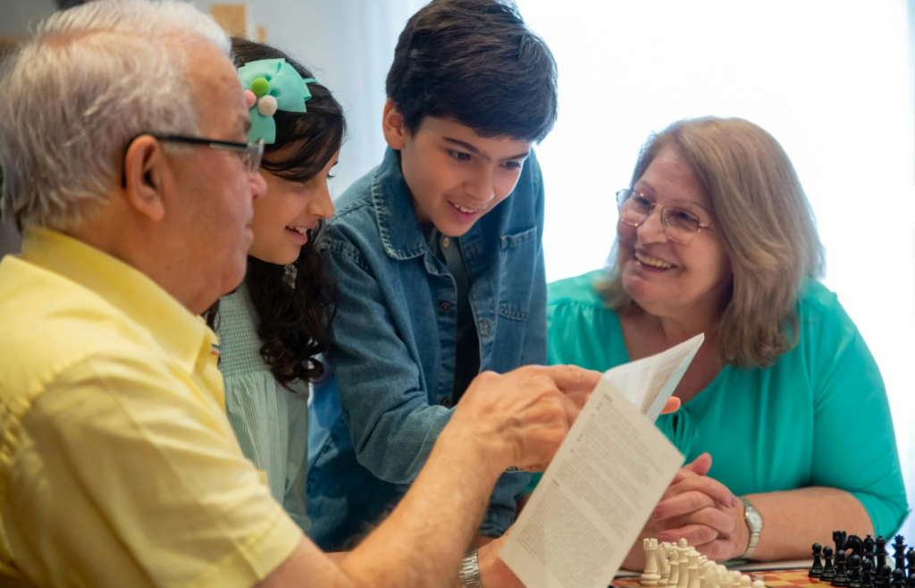 Man and children looking at a paper