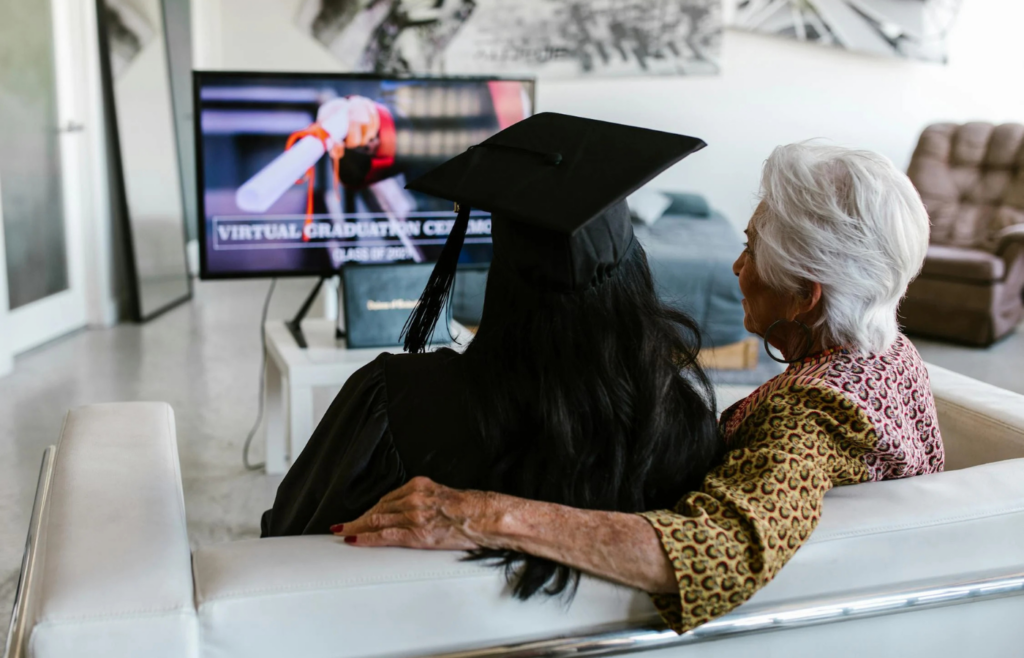 Woman sitting on a couch in front of a television