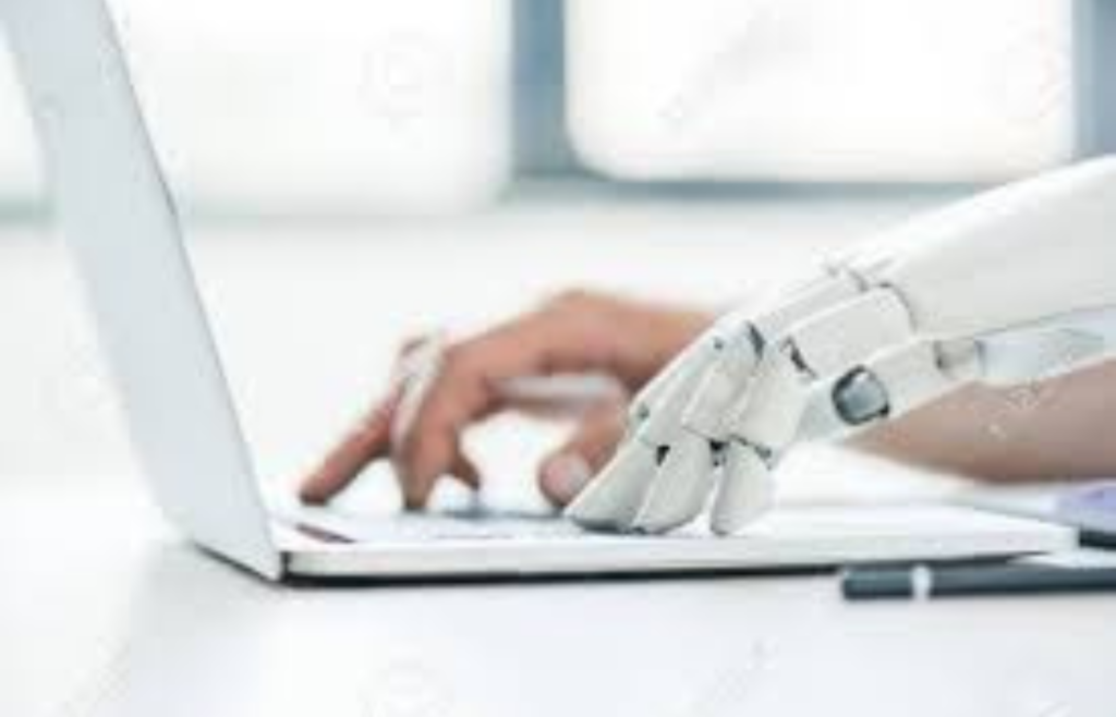 A human and robot hand collaborating over a laptop