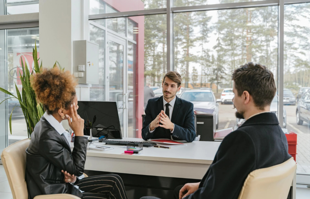 An HR representative sitting between an employee during a discussion