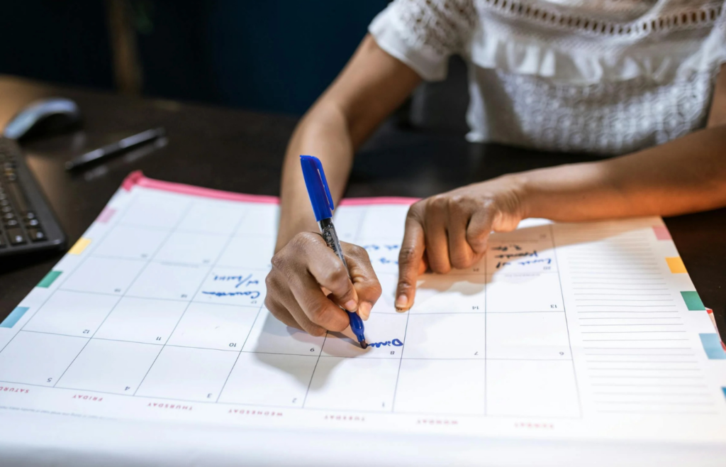 An individual missing family events due to work commitments, with a calendar full of crossed-out personal plans