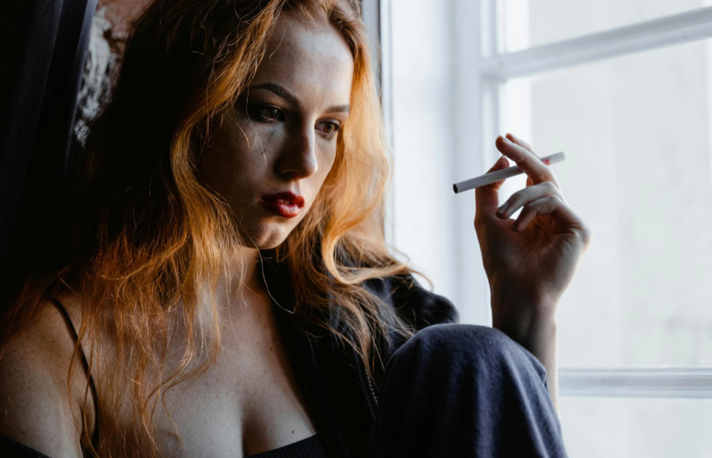 Close-up photo of distressed woman smoking cigarette