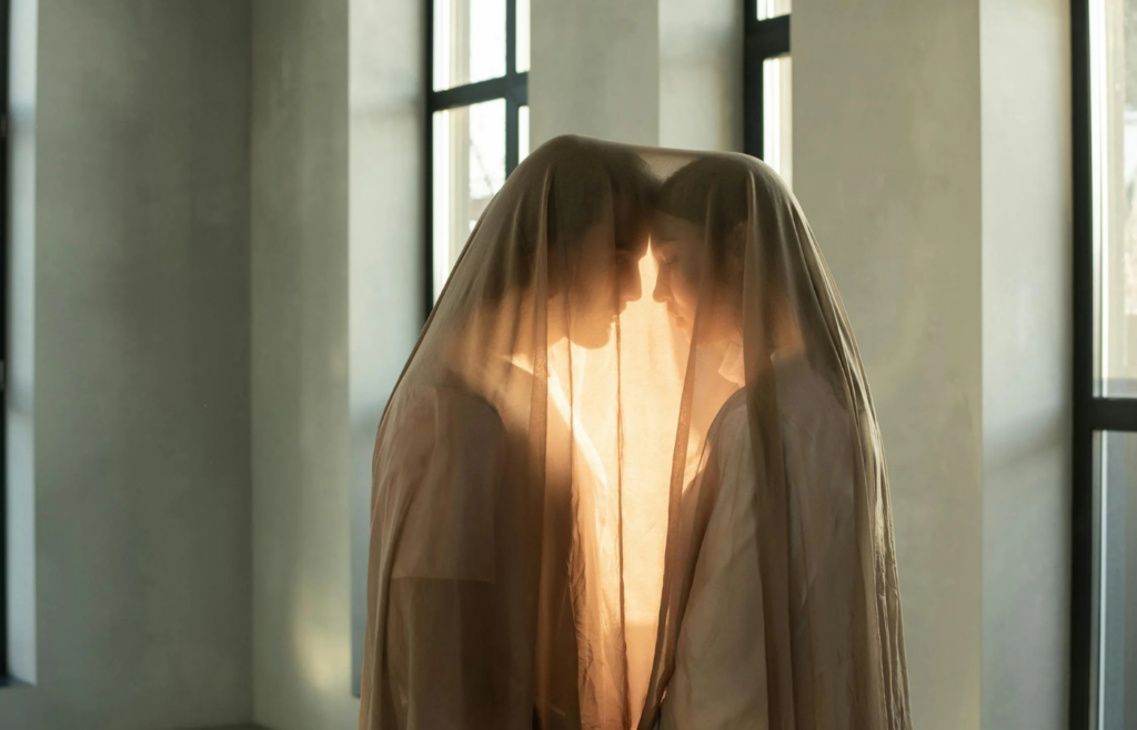 Couple Covered in Sheer Fabric