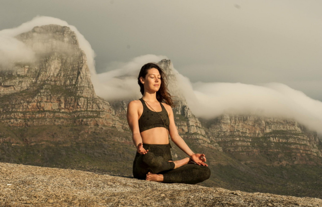 An individual meditating in a peaceful environment