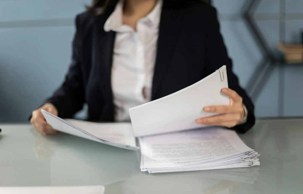 A person reviewing documents on private equity and hedge funds