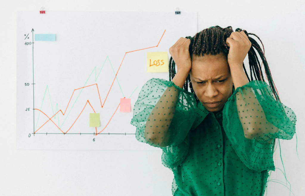 A person hesitating in front of a stock market chart