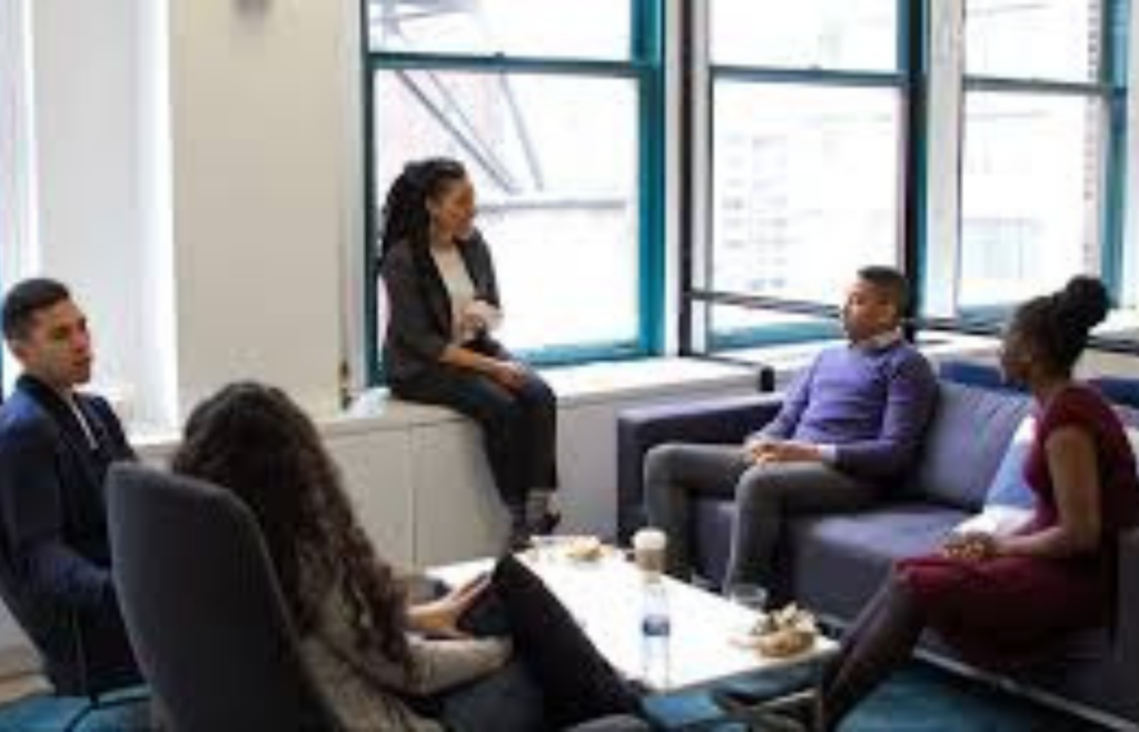 A person sitting silently during a team meeting, despite evident concerns