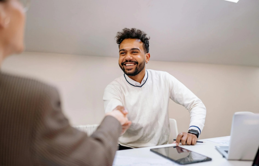 An employee forcing a smile during a stressful meeting
