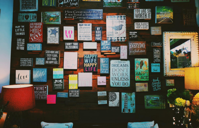 An office wall adorned with motivational quotes about happiness