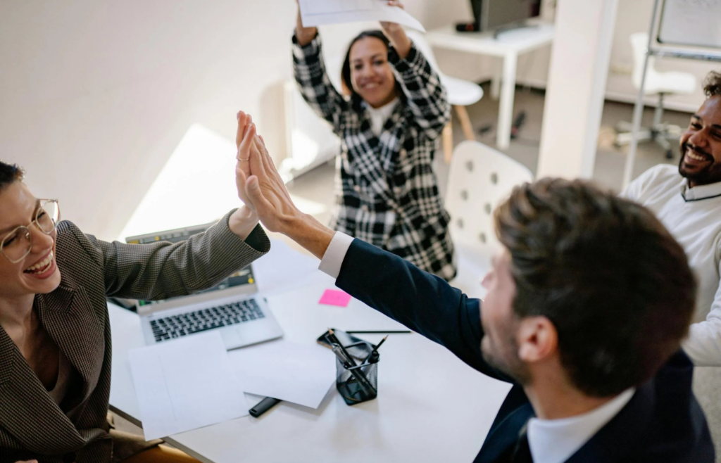 High-five in office teamwork setting