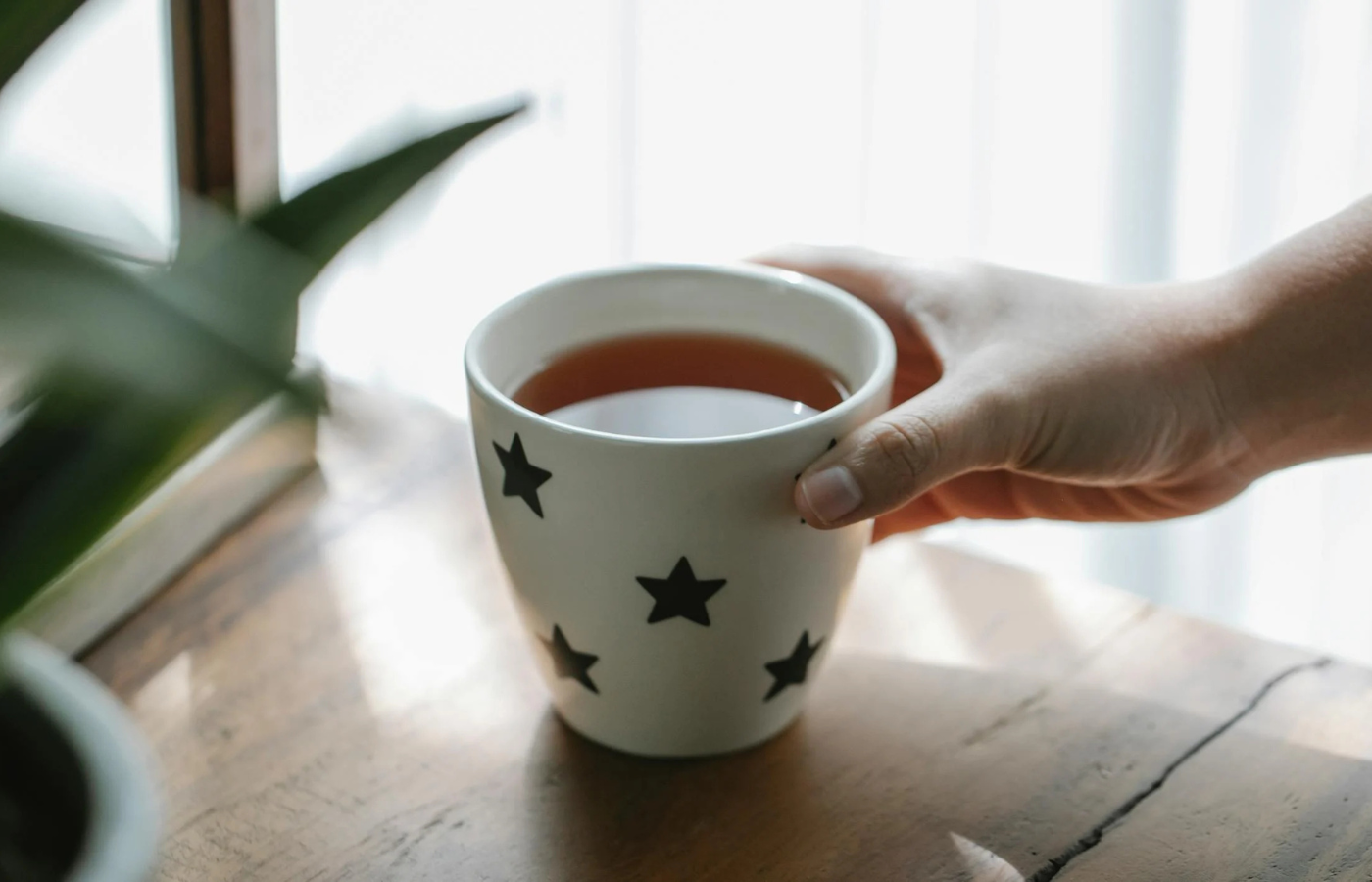 A person choosing herbal tea over coffee