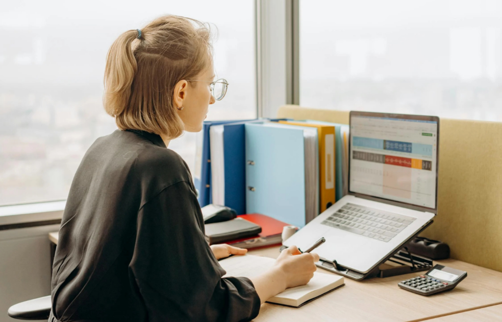 A professional researching salary data on a laptop