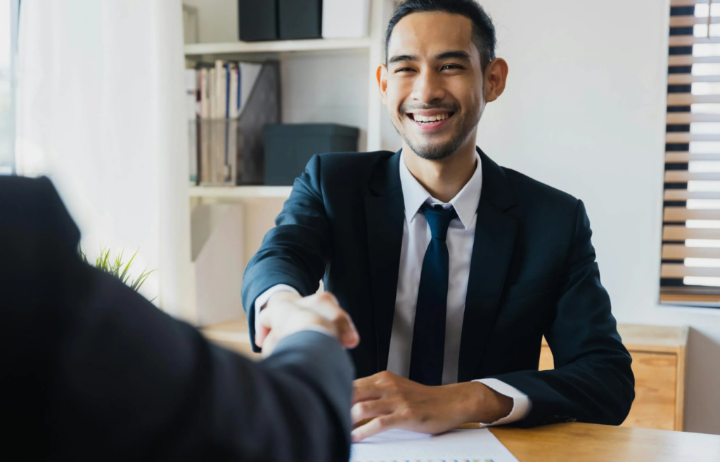 Two people shaking hands, office