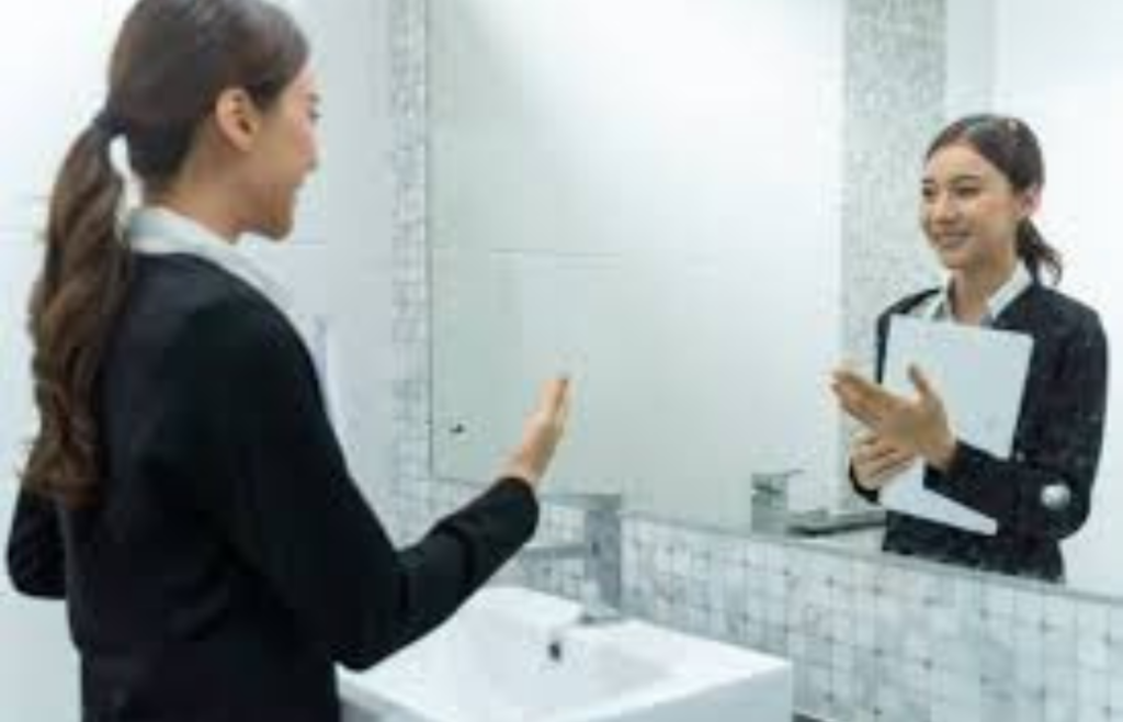 A professional practicing a negotiation conversation in front of a mirror