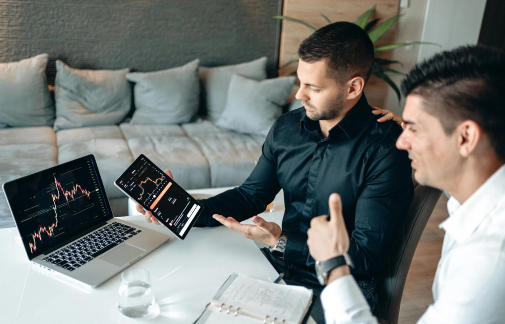 A professional looking at a growing investment portfolio with a smile