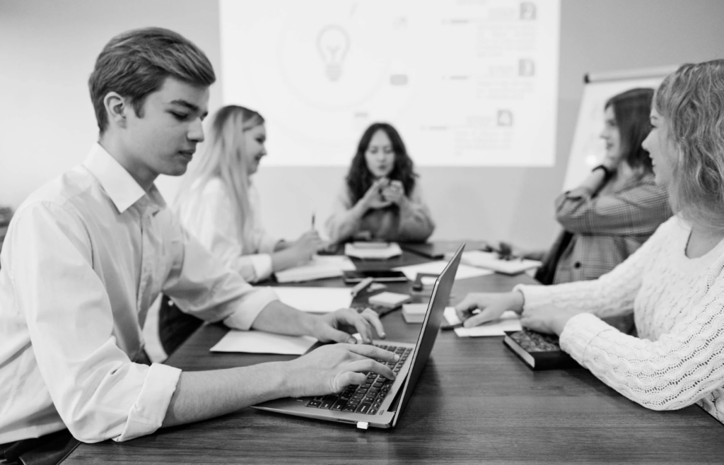 Grayscale Photo of People Working Together