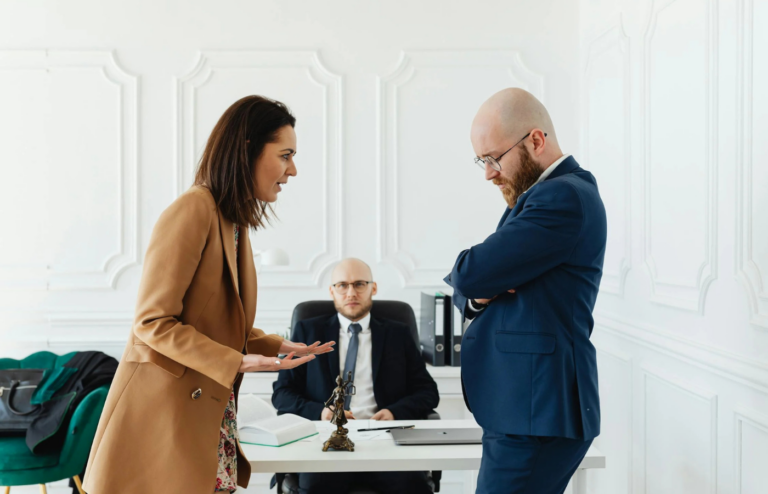 A manager reprimanding an employee harshly in front of colleagues