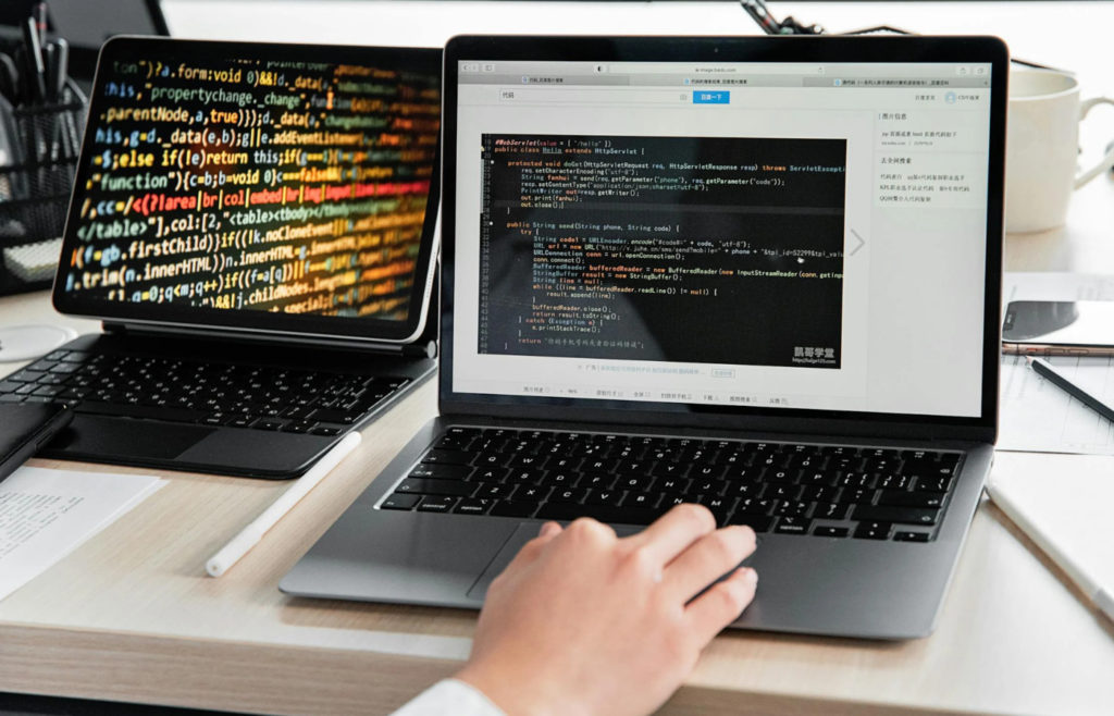A developer coding blockchain applications on multiple screens