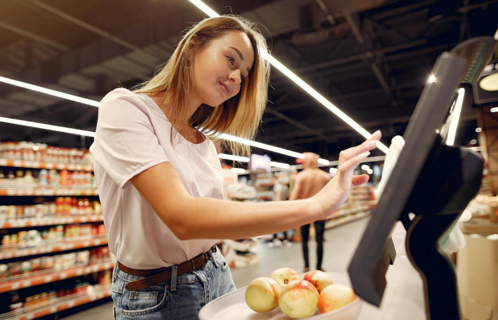 A shopper grabbing items from a store's checkout display impulsively