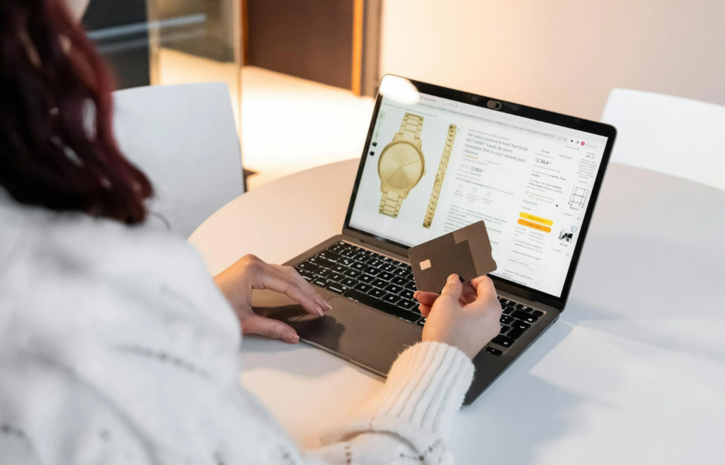 A person using multiple credit cards to pay for luxury items