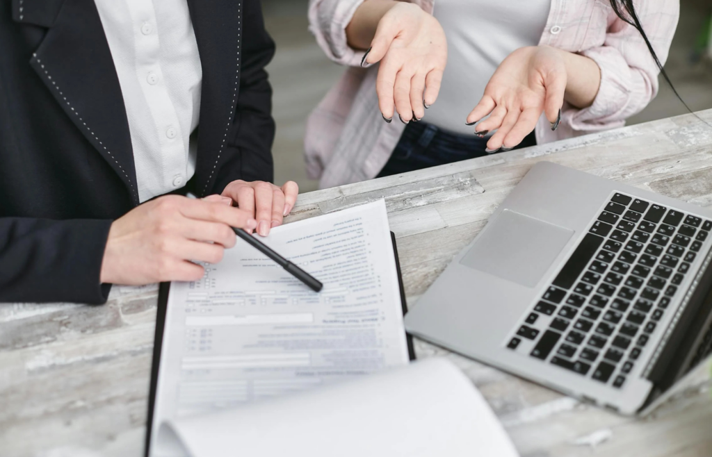 A person comparing insurance quotes on a laptop