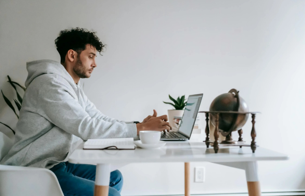 An employee idly browsing the internet with unfinished tasks piling up