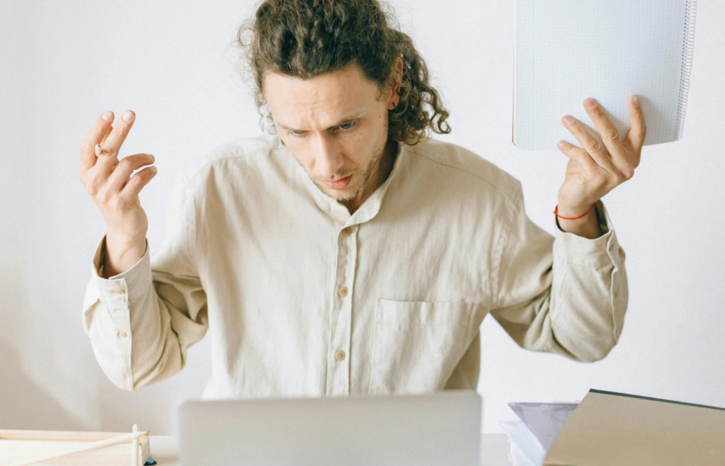 A worker shrugging while claiming to forget about an important deadline