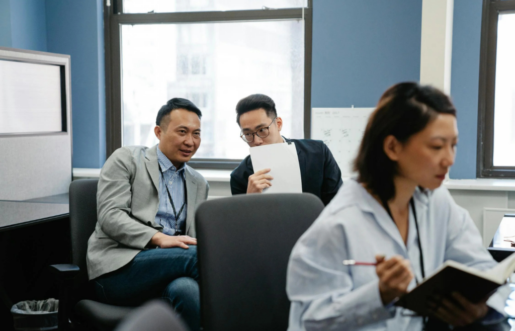 Employees whispering and glancing toward a colleague