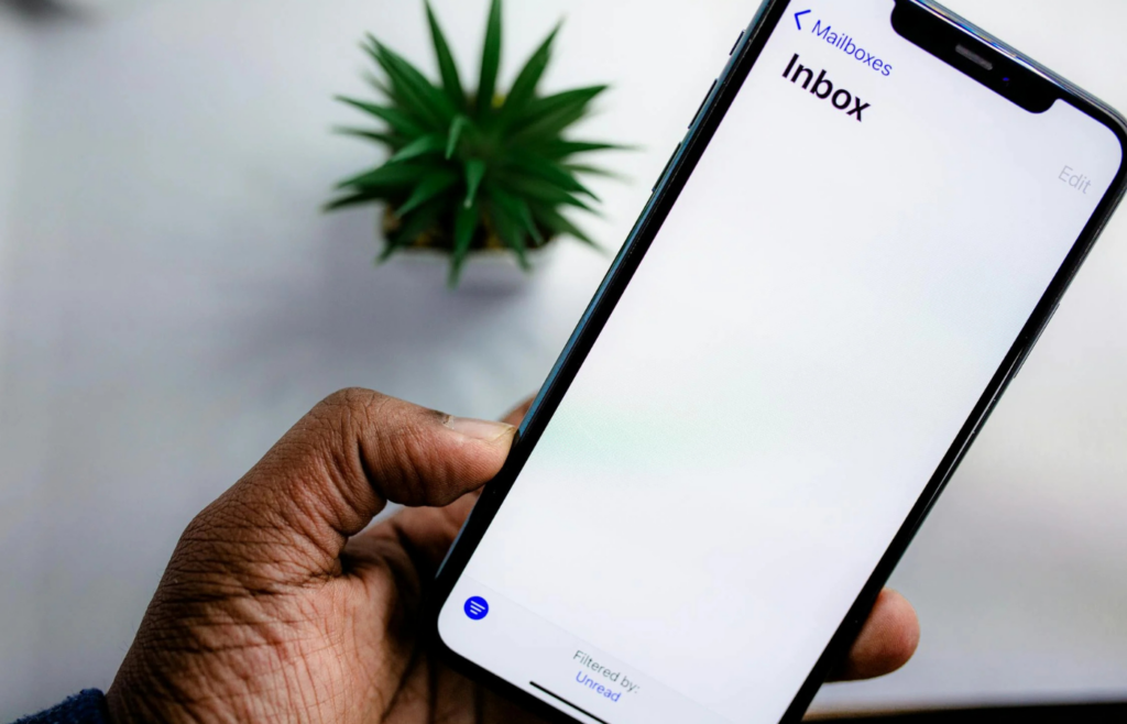 A person repeatedly refreshing their email inbox on a smartphone