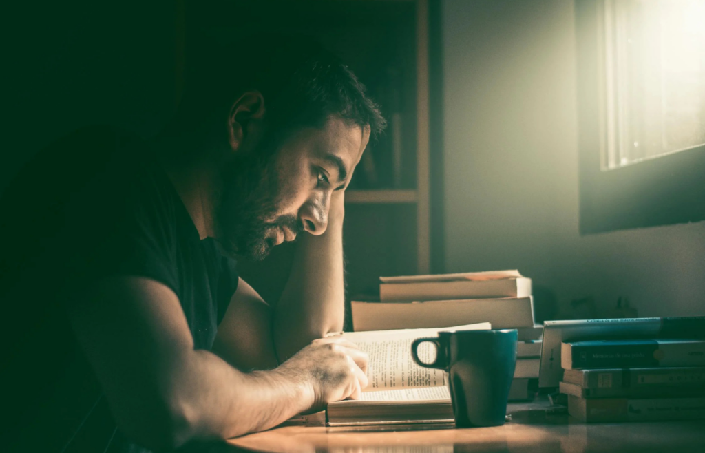 A person overwhelmed by numerous self-help books and articles