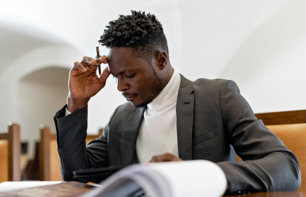 A person repeatedly editing a document, looking frustrated