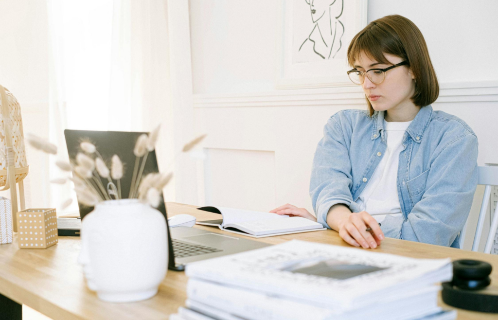 A worker waiting for an email reply with a furrowed brow