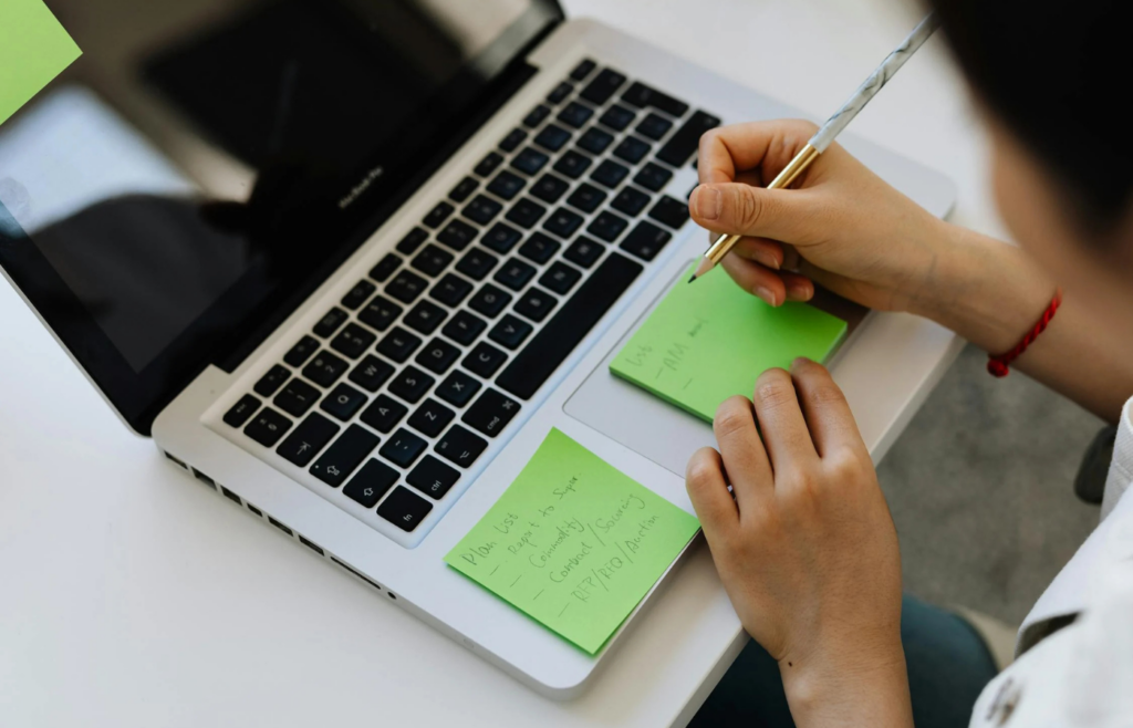 A person preparing a list before a video call