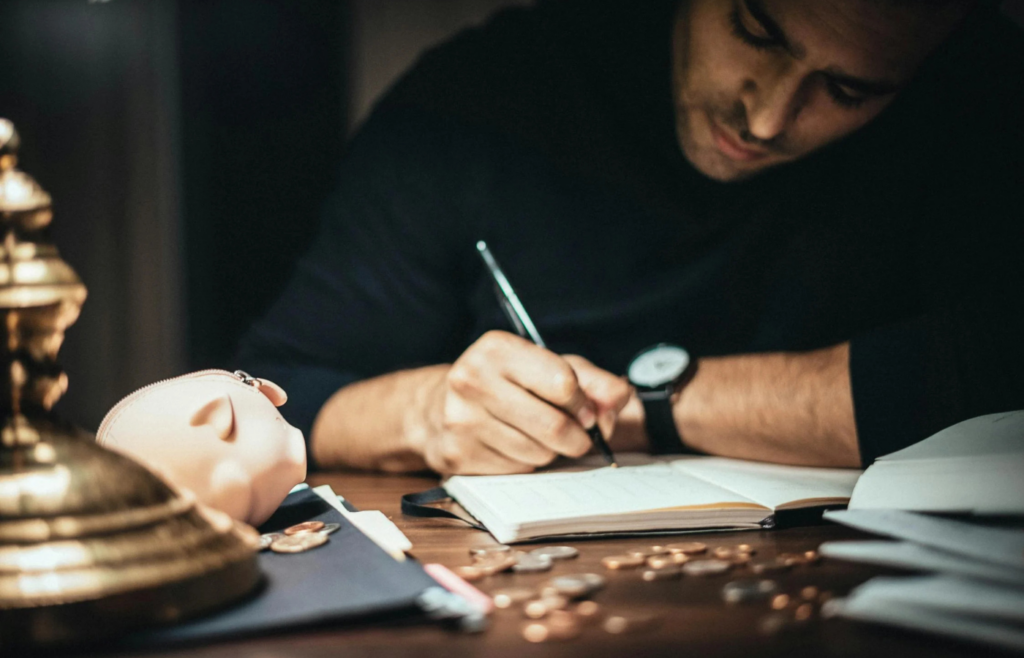 A young professional ignoring a piggy bank on their desk