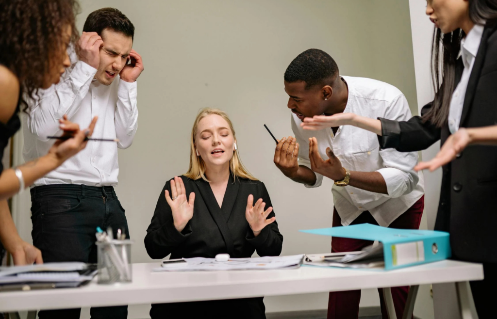 Employees engaged in gossip and conflict in the office