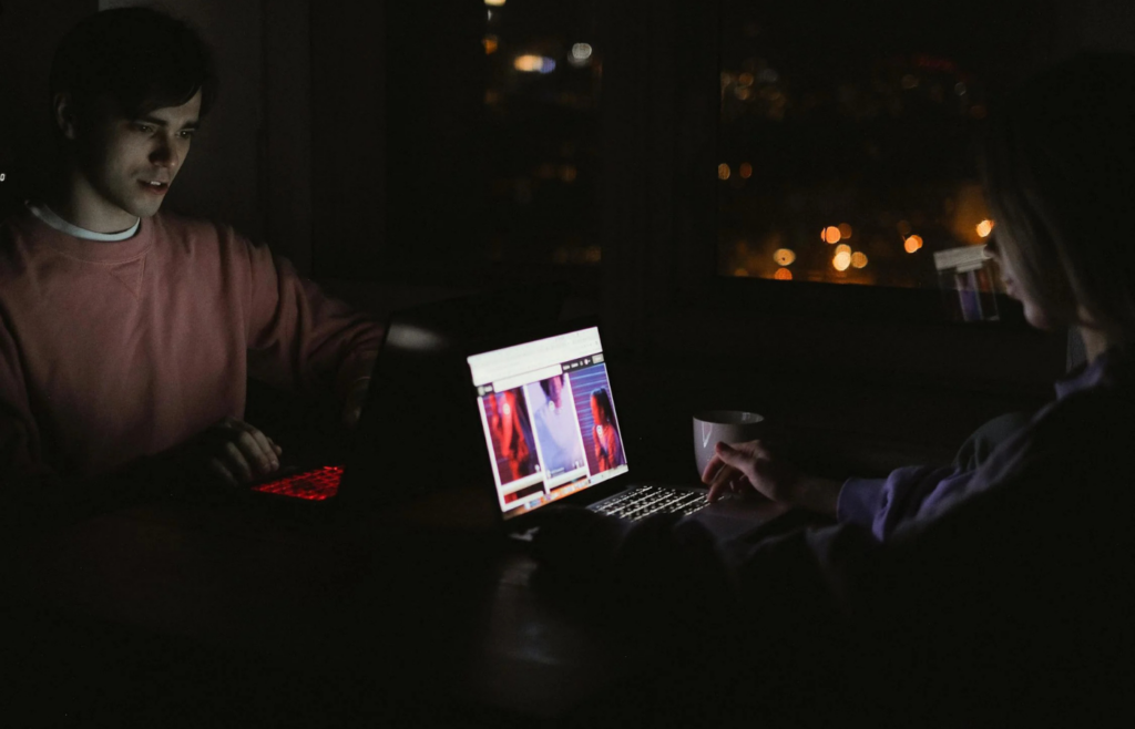 A person working late into the night at home, surrounded by family photos