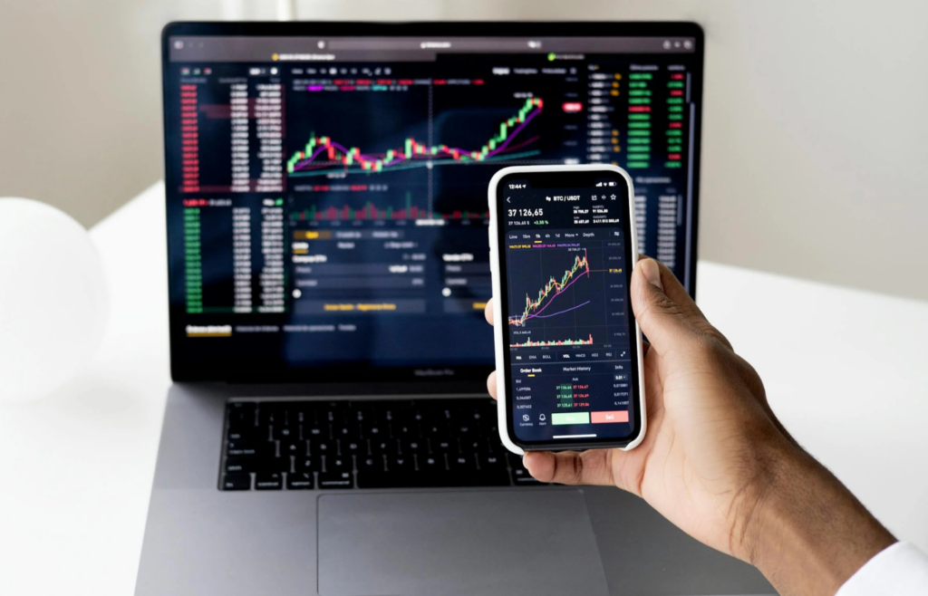 A smartphone displaying a stock trading app with a stock price spiking upward