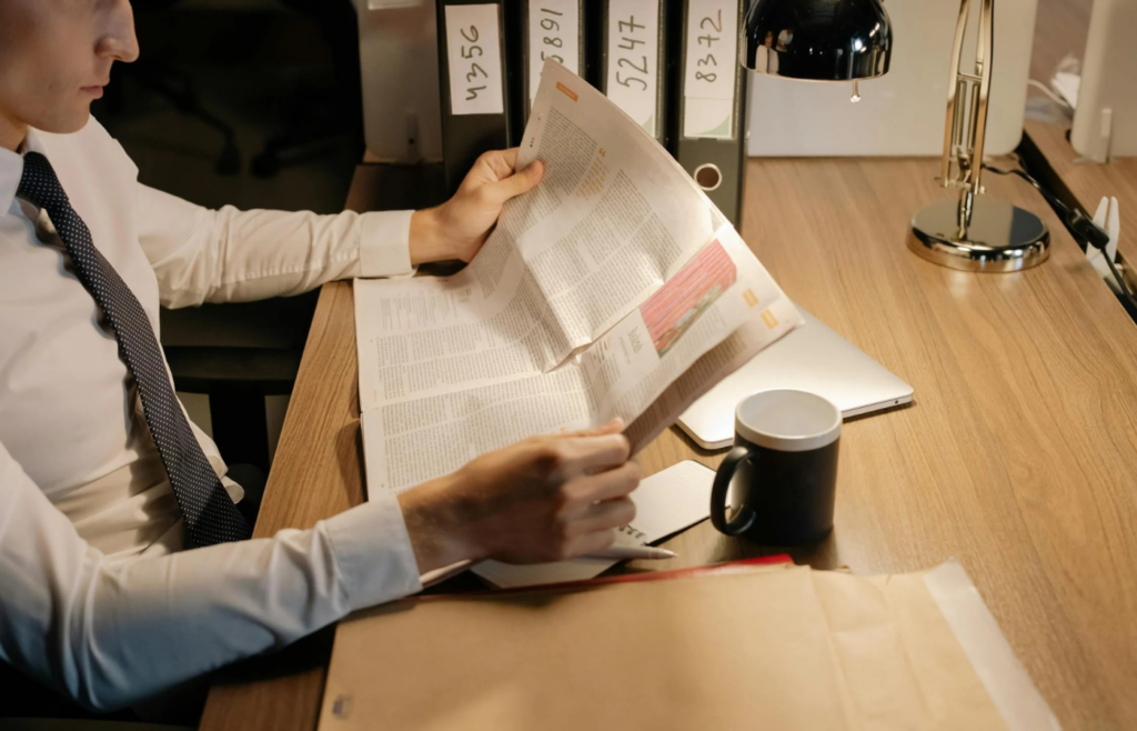  A businessman holding a newspaper with “IPO” in bold letters