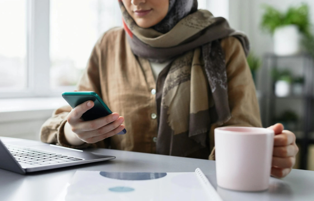 A person happily checking their savings account balance on a phone