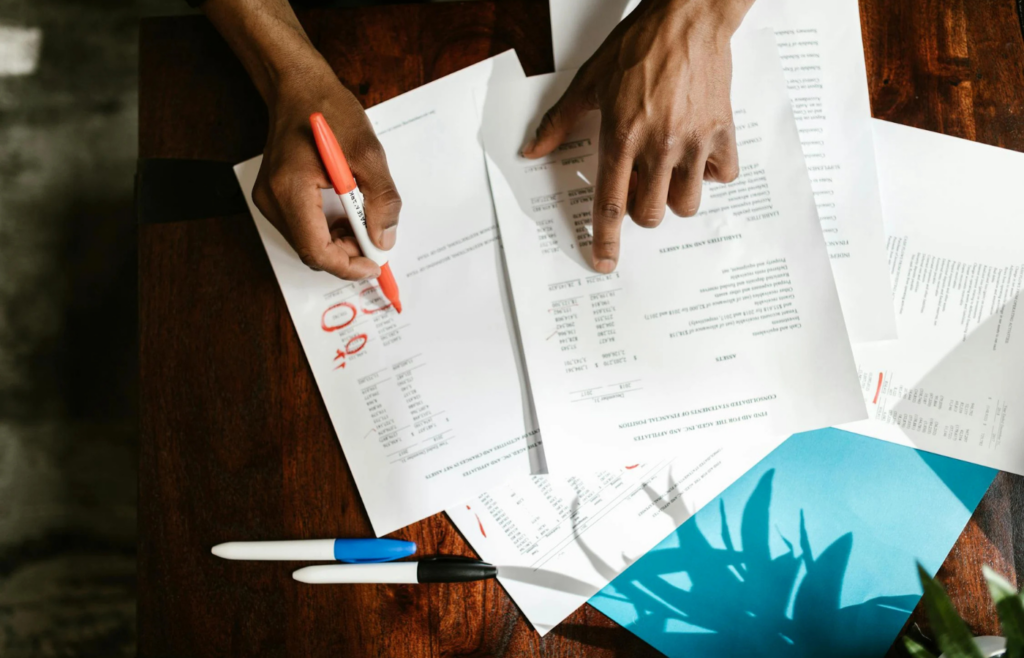 A person reviewing a bank statement with “Money Market Account” highlighted