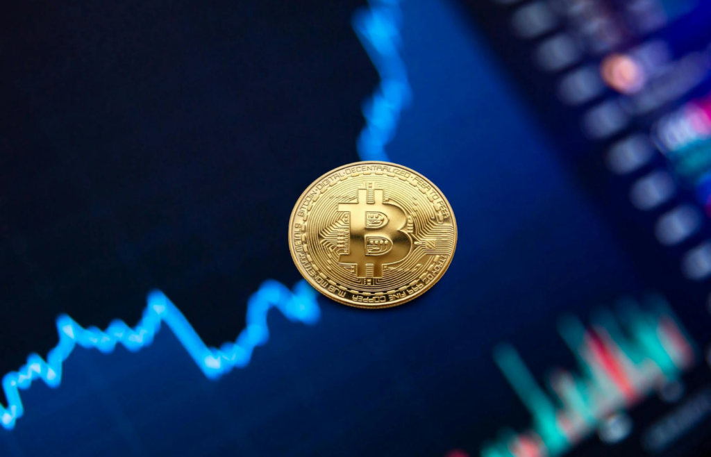 A glowing Bitcoin coin with a stock chart in the background