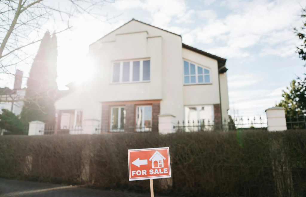 A run-down house with a “Fixer-Upper” sign