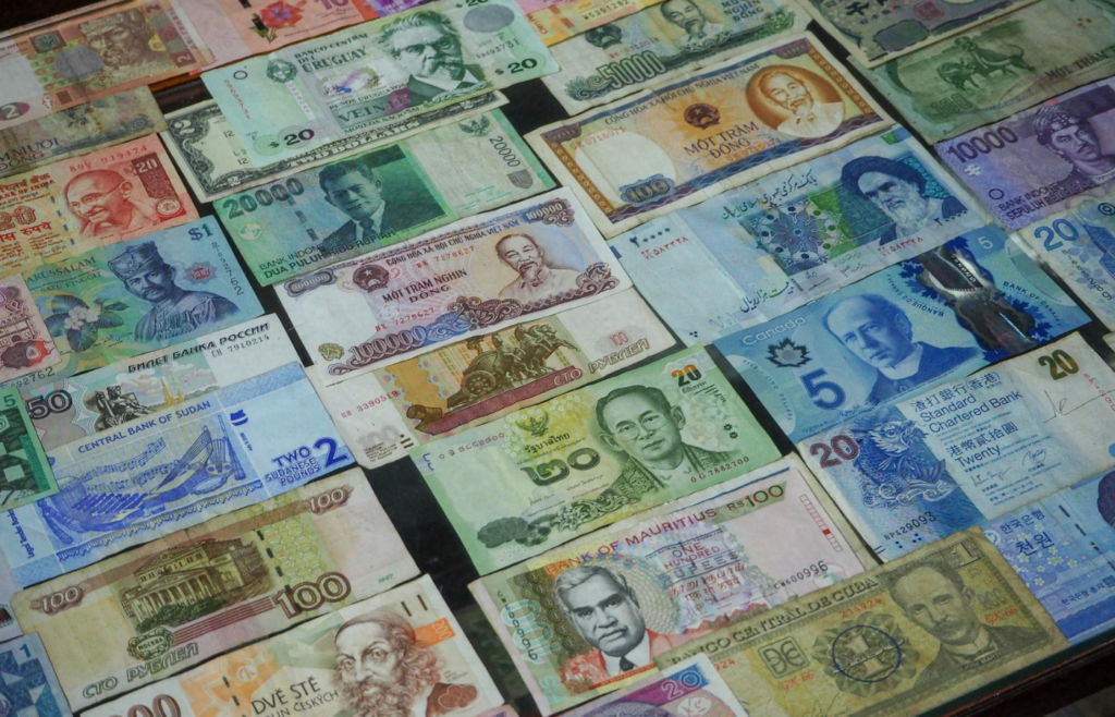 Stacks of different global currencies on a trading desk