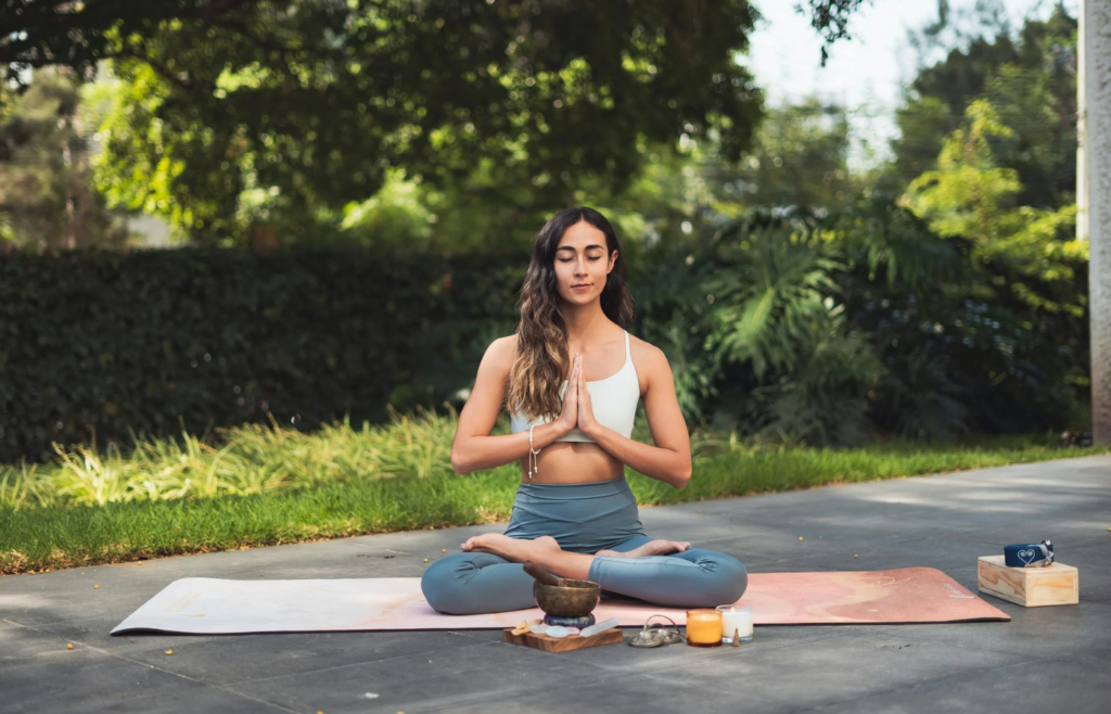 A person meditating in a serene outdoor setting