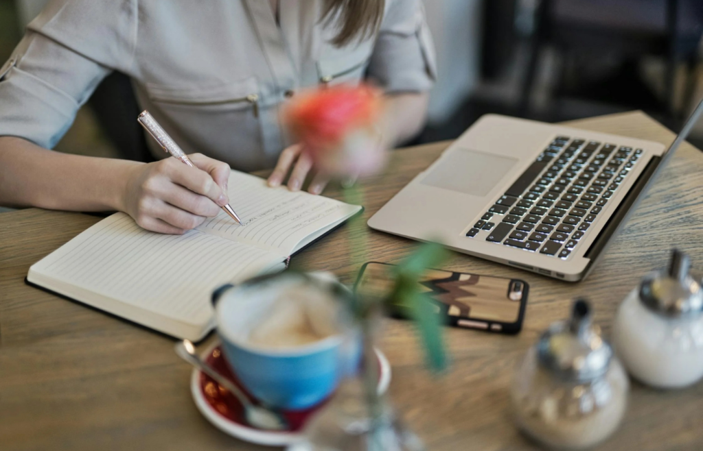 A person writing in a gratitude journal