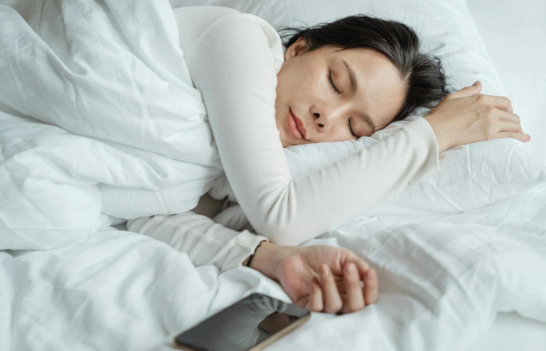 An individual peacefully sleeping in a comfortable bedroom