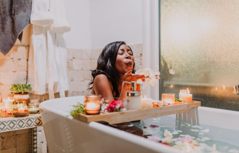 A person enjoying a spa day at home with candles and bath